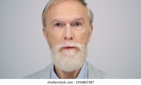 Old Man Portrait With Shocked Face Expression At Grey Background. Surprised Senior Male Person Opening Eyes And Mouth In Studio. Astonished Elderly Gentleman Staying Indoors.