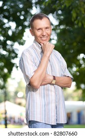 Old man posing for camera in park