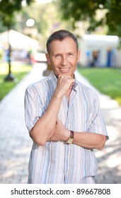 Old man posing for camera in park
