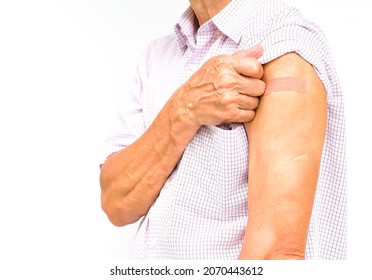 An Old Man Pull The Sleeve At Shoulder Show Adhesive Bandage Plaster On His Arm After Injection Vaccine Isolated On White Background. Concept Covid-19 Vaccine Injection, Vacination In Elderly People