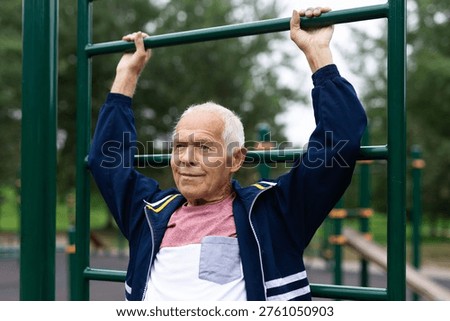Old man pulls himself up on horizontal