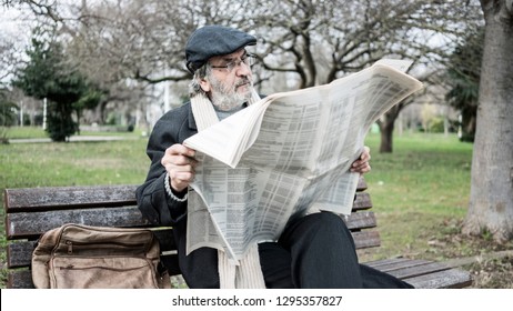 Old Man Reading Newspaper In The Park