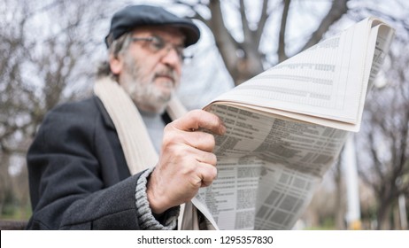 Old Man Reading Newspaper In The Park