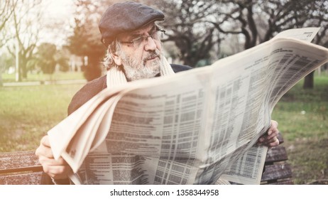 Old Man Reading Newspaper In The Park