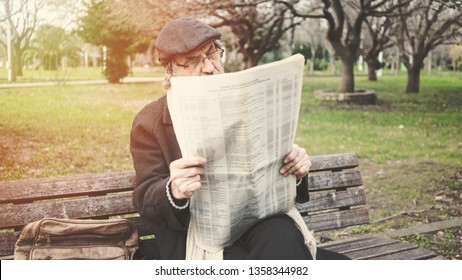 Old Man Reading Newspaper In The Park