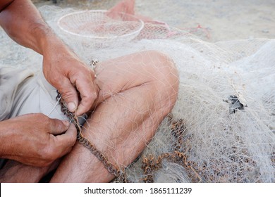 The Old Man Was Repairing The Broken Net. It Is A Device Used To Find Fish In Thailand.