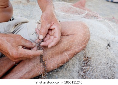 The Old Man Was Repairing The Broken Net. It Is A Device Used To Find Fish In Thailand.