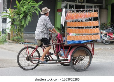 Old Man Riding Tricycle For Sell Fish Snack