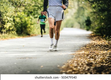 Old Man Running In Autumn Park. Physical Activity And A Healthy Lifestyle