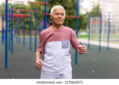 Old Man Running Beside Outdoor Sports Ground