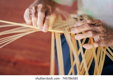 
An Old Man Runs A Wicker Basket With Materials From Bamboo.