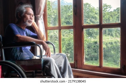 The Old Man Sat In A Wheelchair Alone, Looking At The Window.