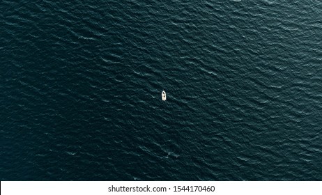 Old man and the sea - top down view of the boat in the middle of Pacific Ocean