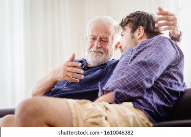 Old Man Serious Discussion With Younger Man Indoor, Grand Father Serious Talking With His Son At Home.