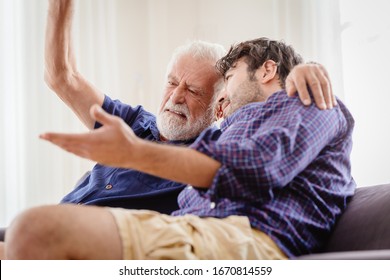 Old Man Serious Discussion With Younger Man Indoor, Grand Father Serious Talking With His Son At Home.