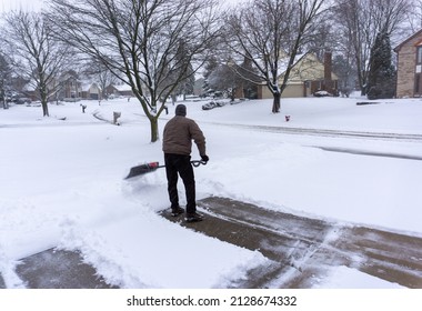 Old Man Shoveling Driveway After Winter Storm