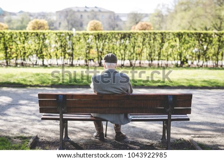 old man sitting on a bench 