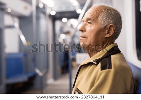Old man sitting in subway car