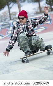 Old Man Skater Is Skating Crouched With His Skateboard On A Skating Park - Focus On The Face