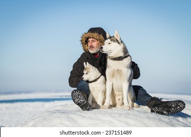 The Old Man and sled dogs on an ice floe.