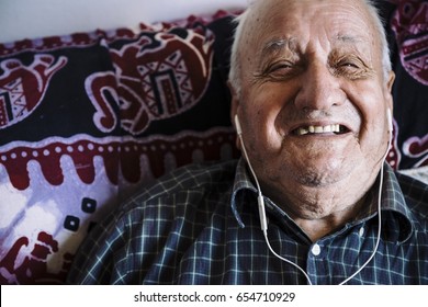 Old Man Sleeping Listening To Music With Headphones