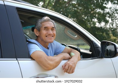 An Old Man Smile In A Car Beside The Road                              