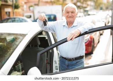 Old Man Standing Beside His Car With Keys In Hand And Looking In Camera.