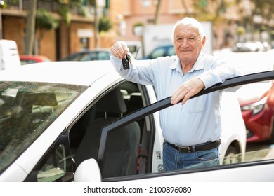 Old Man Standing Beside His Car With Keys In Hand And Looking In Camera.