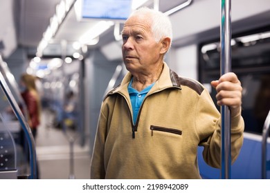 Old Man Standing In Subway Car