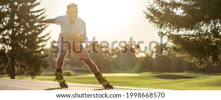 The old man in sunglasses rollerblading outdoor