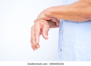 an old man support his arms which pain,numbness,weakness,paralysis (isolated on white background with copy space), concept of Guillain barre syndrome caused by autoimmune disorder.selective focus 
