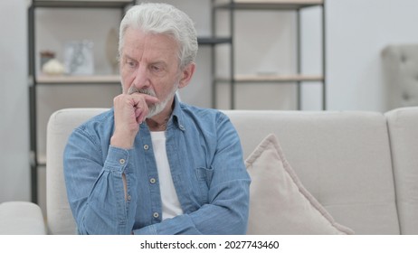 Old Man Thinking While Sitting on Sofa 
