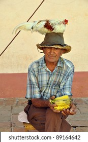 Old Man In Trinidad, Cuba, With Chicken On Head