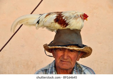 Old Man In Trinidad, Cuba, With Chicken On Head