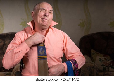 Old Man Is Trying On A Tie With Dissatisfied Face