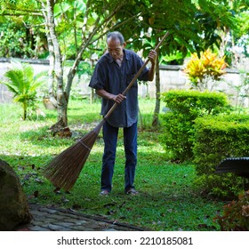 Old Man Using A Broom
 Sweeping Leaves October 4, 2022 In Chiang Rai, Thailand.