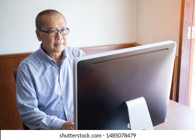 an old man using computer and stress looking or watching desktop monitor for business financial monitoring, elder working at home, retired man hobby