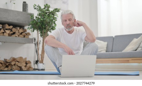 Old Man Using Laptop On Excercise Mat At Home