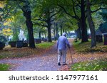 Old man walk in the cementary