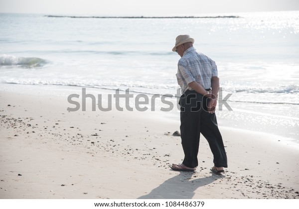 Old Man Walking Alone On Beach Stock Photo (Edit Now) 1084486379