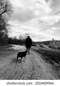 Old Man Walking With His Dog. 