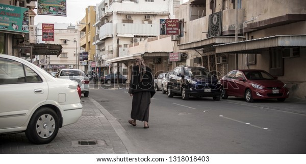 old man walking in street picture\
taken in manama city kingdom of bahrain at 16 feb\
2019.