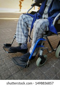 Old Man Wearing Plaid Pajamas Sitting On The Wheelchair Outside The Hospital