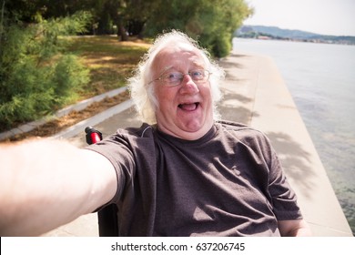 Old Man In Wheelchair Taking A Selfie