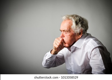 Old Man In White Is Coughing. Symptoms And Disease.