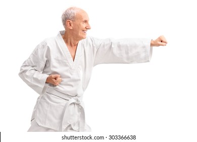 Old Man In A White Kimono Practicing Karate Isolated On White Background