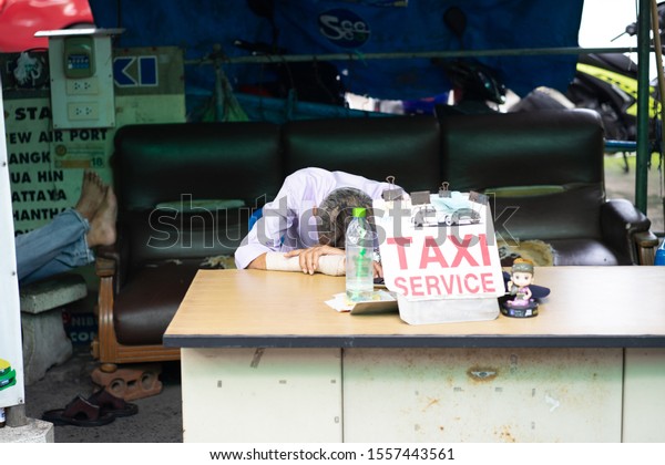 An old man who is tired of working His career is\
a low-income taxi driver because of a bad economy. Sleeping just 5\
minutes may improve him.Photographed on 15 May BE 2562 16:40 at\
Rayong Thailand