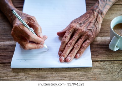  Old Man Writing With A Pencil In A Notebook,Handwriting