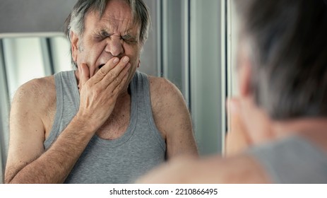 Old Man Yawning In Front Of Mirror