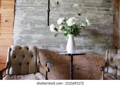 Old Manor Interior With A Arm Chair And Vase With White Flowers. Latvia.